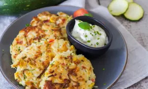 Herzhafte Reispuffer mit Zucchini und Paprika, perfekt, um Reis zu verwerten. Dazu ein Dip mit Kräutern.